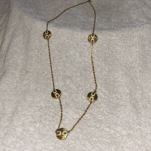 Long gold brass chain necklace with round designs on it